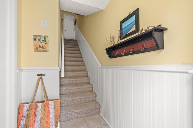 stairs featuring tile patterned floors