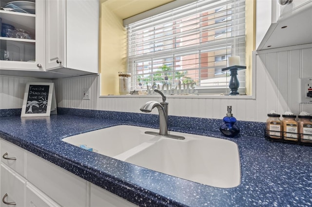 details with white cabinets and sink