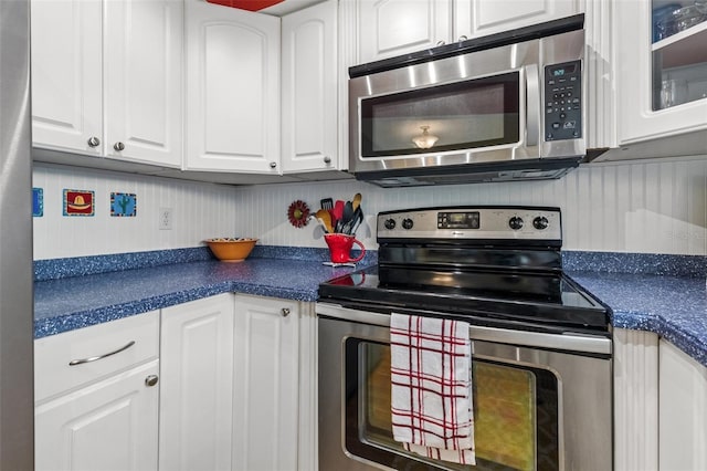 kitchen featuring white cabinets and appliances with stainless steel finishes