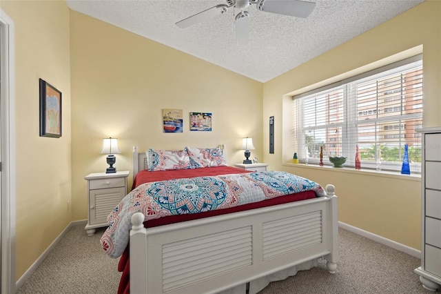 carpeted bedroom featuring a textured ceiling, ceiling fan, and lofted ceiling