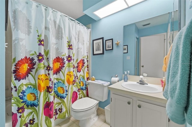 bathroom with tile patterned floors, vanity, and toilet