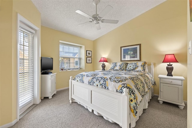 carpeted bedroom with ceiling fan, a textured ceiling, and vaulted ceiling