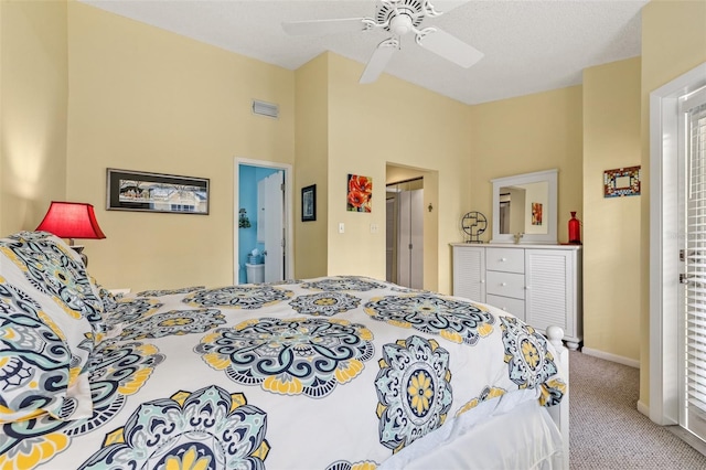 carpeted bedroom featuring ceiling fan, a textured ceiling, and connected bathroom