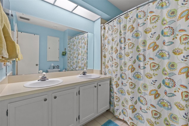 bathroom with vanity, tile patterned floors, and walk in shower