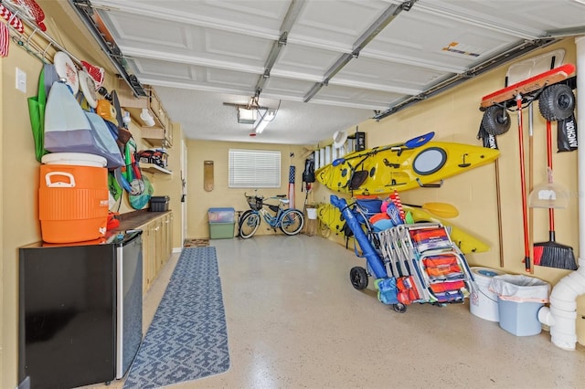 garage featuring a garage door opener and fridge