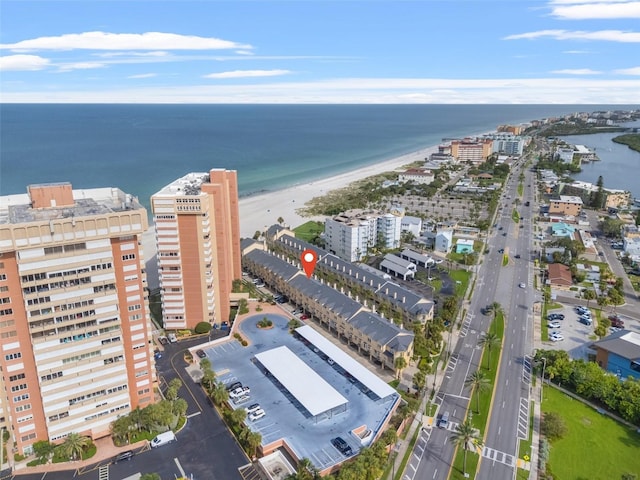 birds eye view of property featuring a beach view and a water view