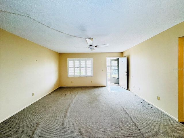 empty room with a textured ceiling, carpet floors, and ceiling fan