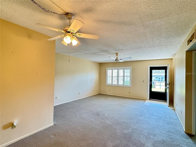 carpeted empty room with a textured ceiling and ceiling fan