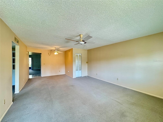 carpeted empty room featuring a textured ceiling and ceiling fan