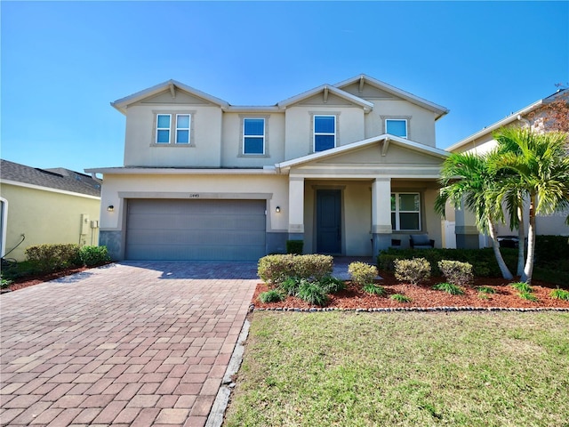 view of front of house with a garage and a front lawn