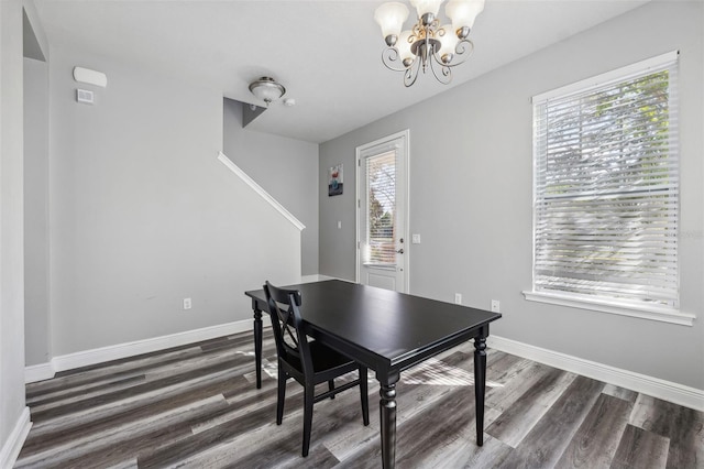 dining room featuring a notable chandelier and dark hardwood / wood-style floors