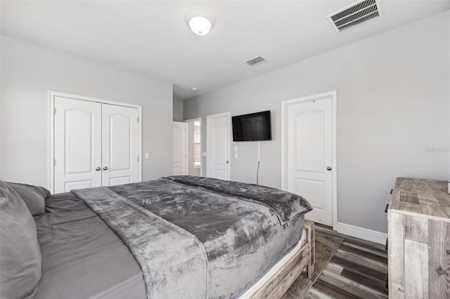 bedroom with dark hardwood / wood-style flooring