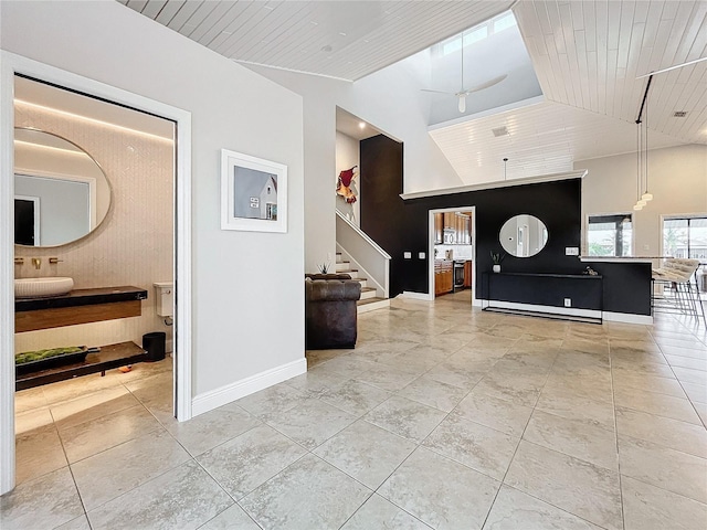 entryway with high vaulted ceiling, ceiling fan, and wooden ceiling