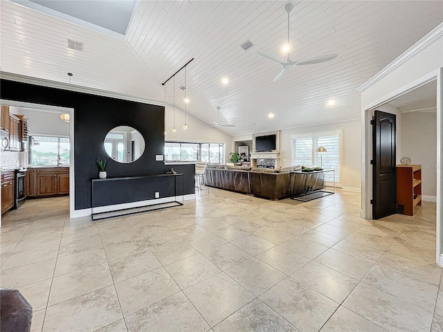 living room with ceiling fan, wood ceiling, a wealth of natural light, and high vaulted ceiling