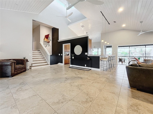 living room featuring high vaulted ceiling, ceiling fan, and wood ceiling