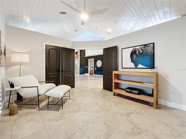 living area featuring ceiling fan and vaulted ceiling