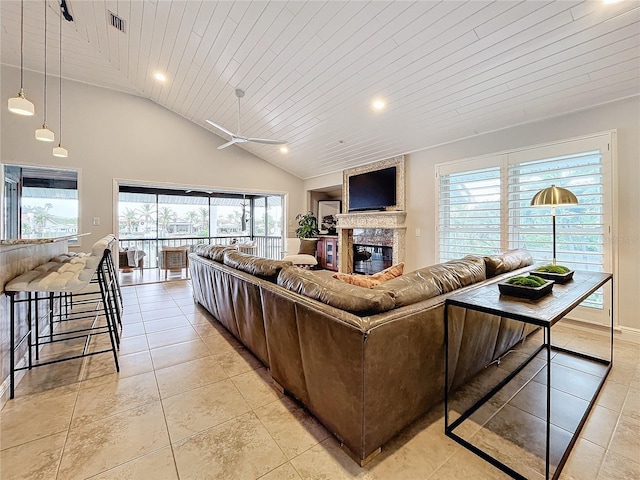 tiled living room featuring a high end fireplace, wooden ceiling, and a wealth of natural light