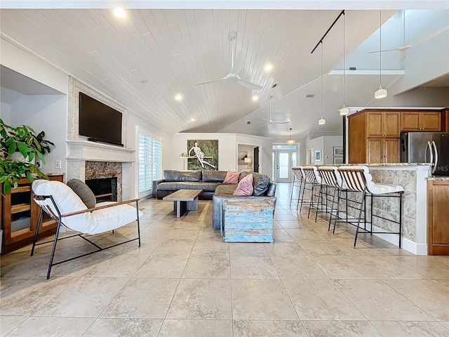 living room with ceiling fan, wooden ceiling, and lofted ceiling