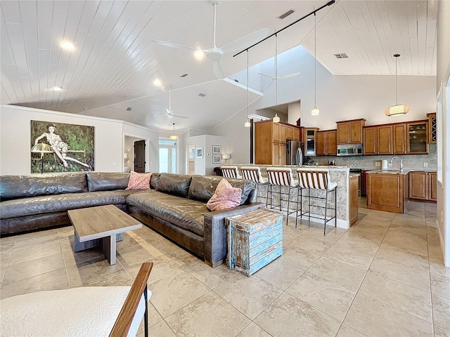 living room featuring high vaulted ceiling, ceiling fan, wooden ceiling, and sink