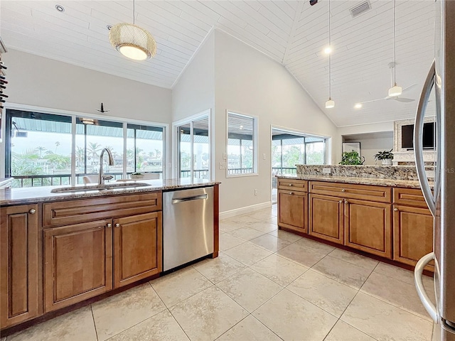 kitchen with stainless steel appliances, sink, ceiling fan, hanging light fixtures, and high vaulted ceiling