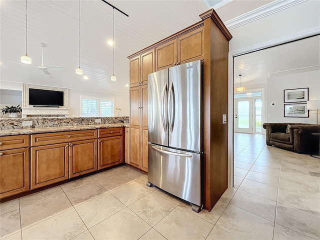 kitchen with stainless steel refrigerator, ceiling fan, pendant lighting, and plenty of natural light