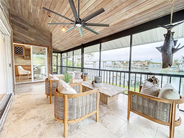 sunroom featuring ceiling fan, a water view, wooden ceiling, and lofted ceiling