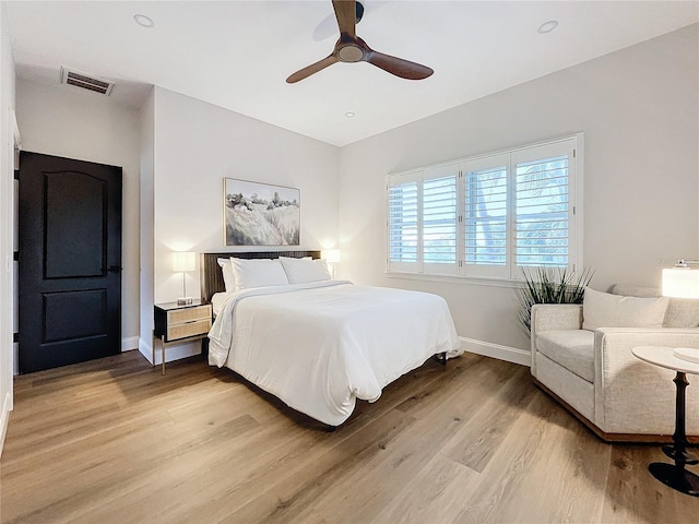 bedroom with ceiling fan and light hardwood / wood-style floors