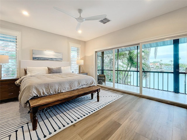 bedroom featuring ceiling fan, light hardwood / wood-style flooring, and access to exterior