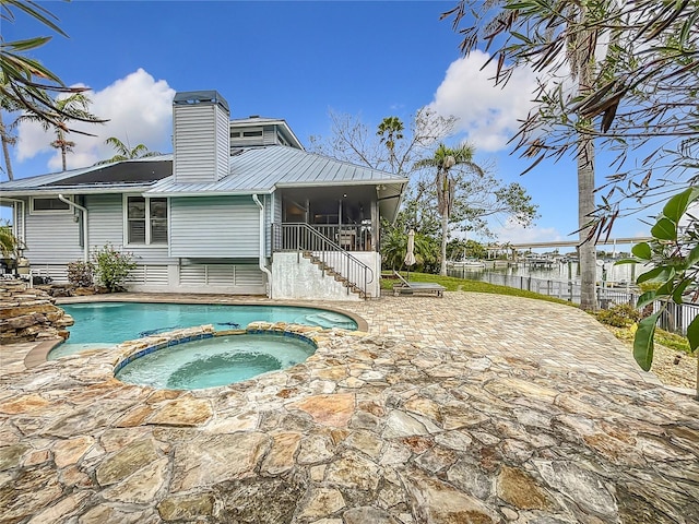 view of swimming pool with a patio and an in ground hot tub