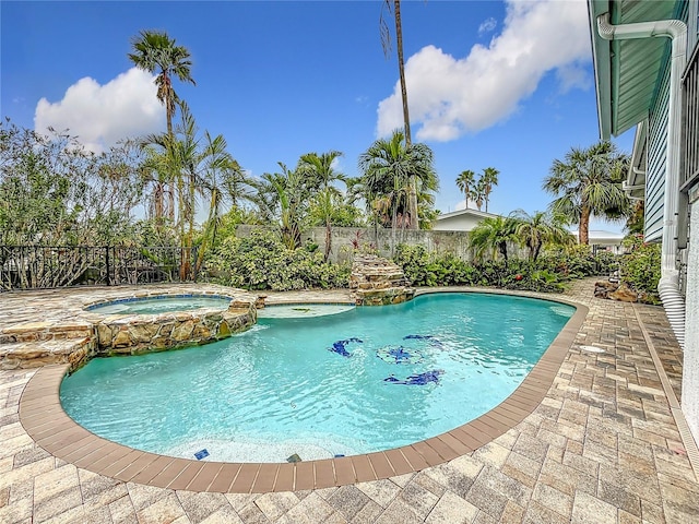 view of pool with pool water feature, an in ground hot tub, and a patio