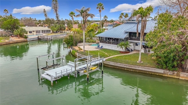 dock area featuring a yard and a water view