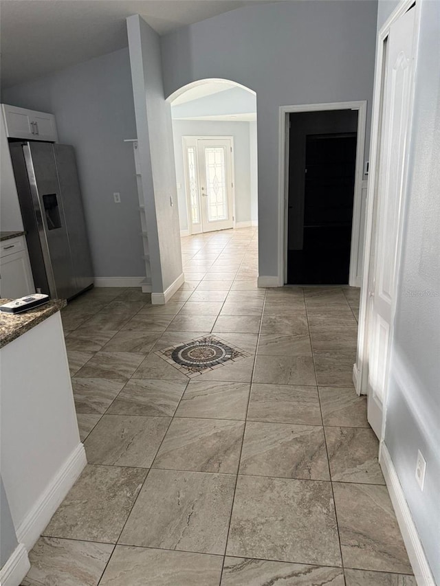 kitchen with white cabinetry and stainless steel fridge with ice dispenser