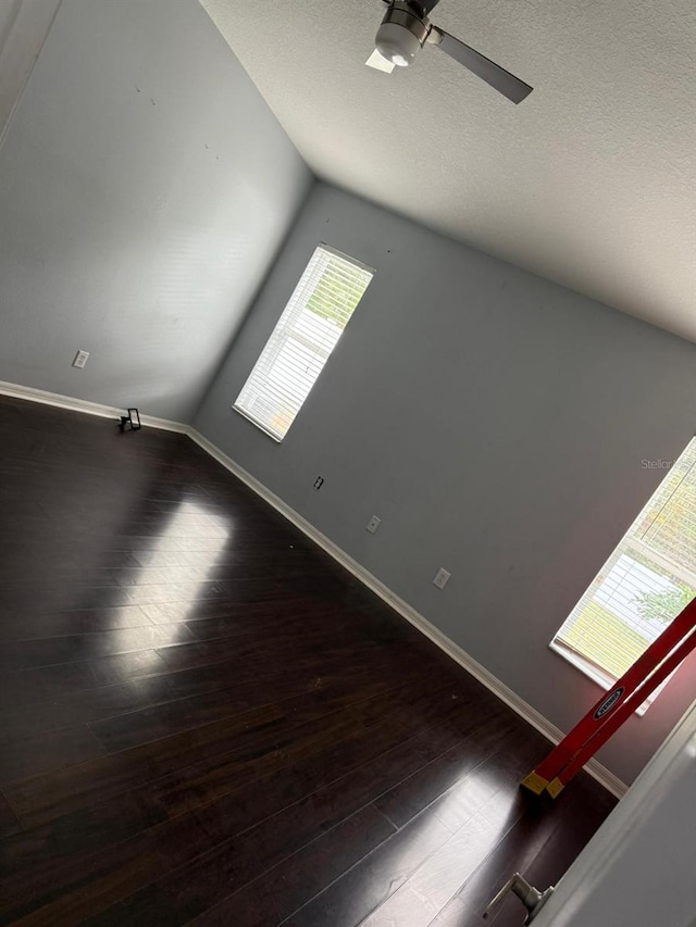 spare room with ceiling fan and dark wood-type flooring