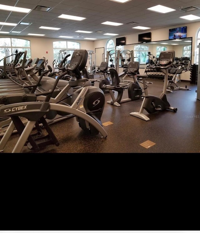 exercise room with a paneled ceiling