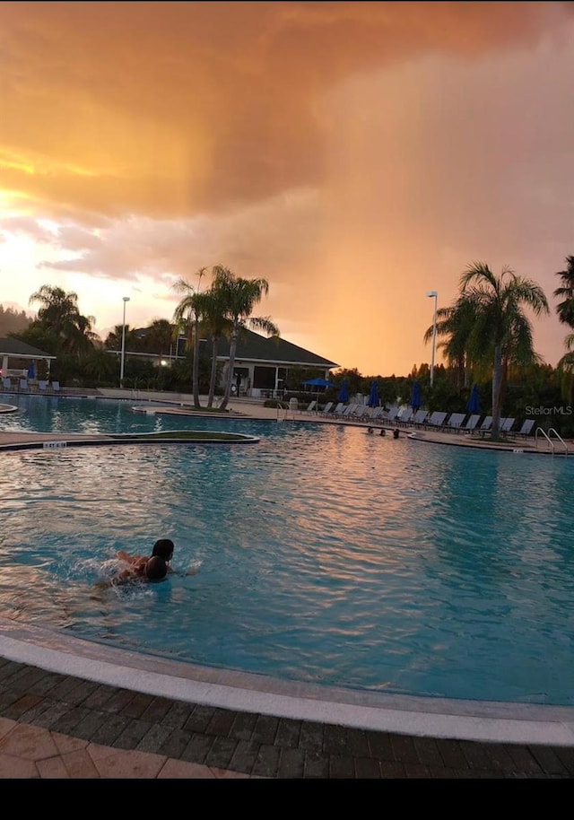 view of pool at dusk