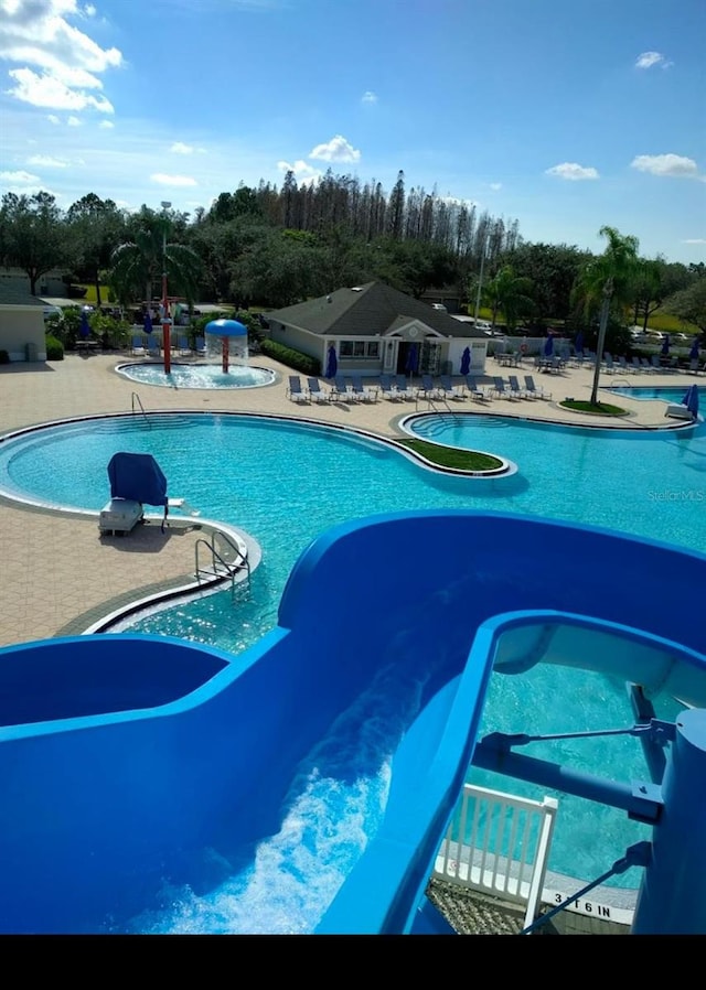 view of swimming pool with a water slide