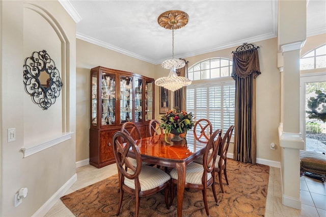 tiled dining space featuring ornamental molding and decorative columns