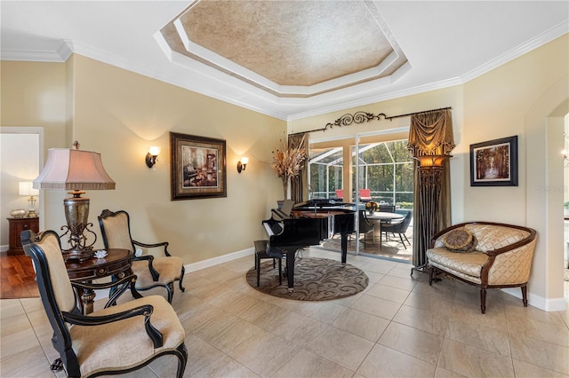 living area featuring crown molding, a tray ceiling, and light tile patterned floors