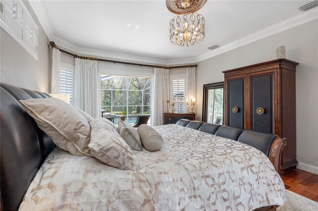 bedroom featuring multiple windows, hardwood / wood-style floors, crown molding, and a chandelier