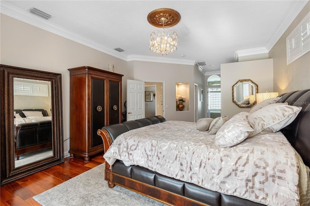 bedroom with ornamental molding, dark hardwood / wood-style floors, a notable chandelier, and a closet