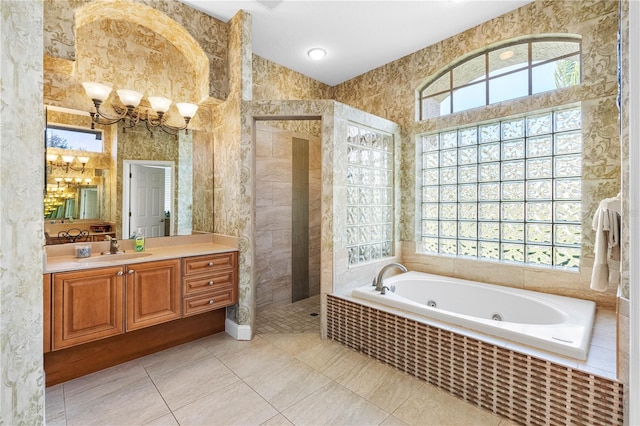 bathroom with vanity, tile patterned flooring, and a healthy amount of sunlight