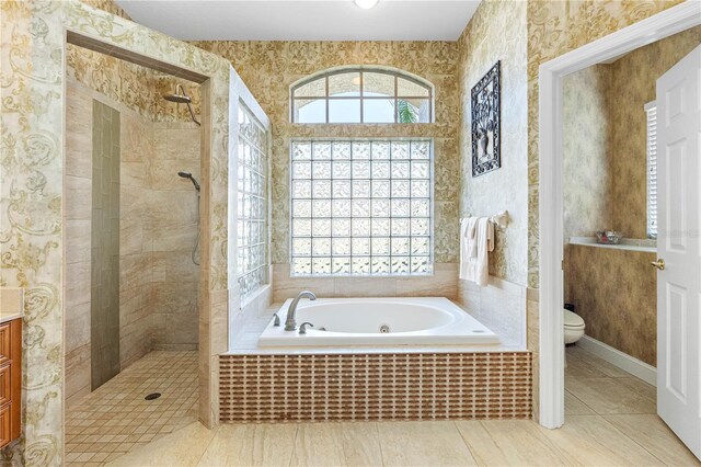 full bathroom with tile patterned flooring, vanity, independent shower and bath, and toilet