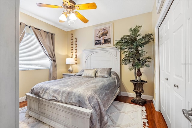 bedroom with wood-type flooring, ceiling fan, and a closet