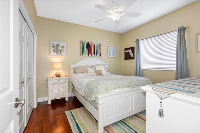 bedroom featuring ceiling fan, dark hardwood / wood-style flooring, and a closet