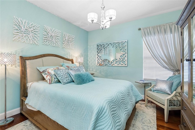 bedroom with an inviting chandelier and wood-type flooring