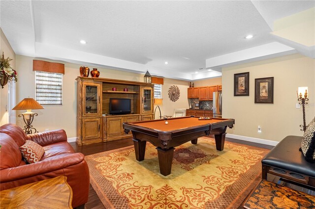 recreation room with pool table, a raised ceiling, and light wood-type flooring