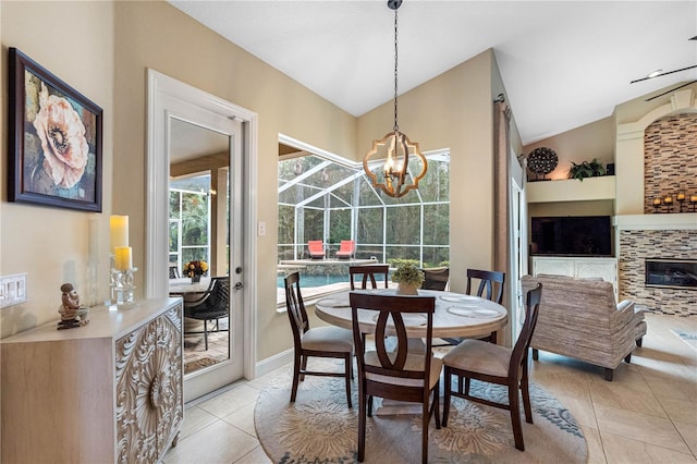 dining space with light tile patterned floors and vaulted ceiling