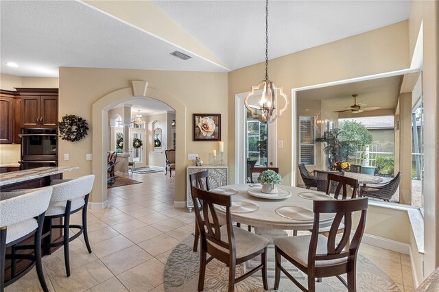 dining room featuring lofted ceiling, a chandelier, and light tile patterned floors