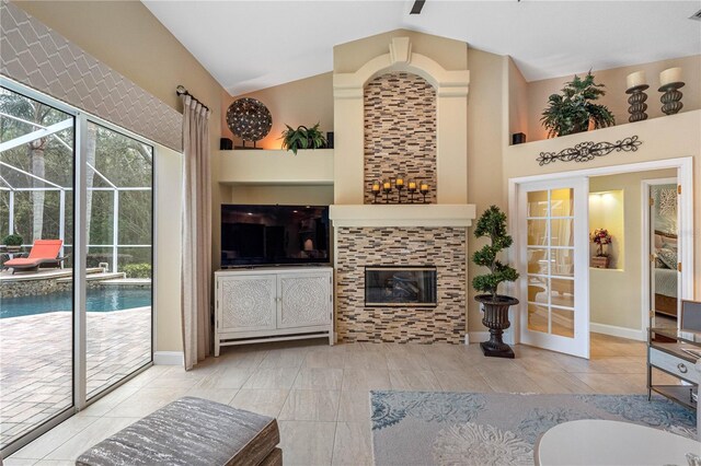 living room with high vaulted ceiling and a tile fireplace