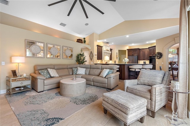 living room featuring ceiling fan and high vaulted ceiling